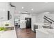 Bright kitchen with white cabinets, stainless steel appliances, and hardwood floors, offering a modern design at 2432 Riviera Ln, Minneola, FL 34715