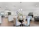 Open living area includes a dining area, kitchen, and living room with hardwood flooring and modern decor at 2432 Riviera Ln, Minneola, FL 34715