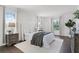 Main bedroom with sitting area, large windows for natural light and wood-look flooring at 2432 Riviera Ln, Minneola, FL 34715