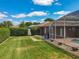 Picture of the backyard showing the screened-in patio and pool. Mature landscaping surrounds the property at 2558 Ballard Ave, Orlando, FL 32833