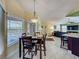 Bright dining area features a large window for natural light and dark wooden table set at 2558 Ballard Ave, Orlando, FL 32833