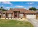 Beautiful home boasts a manicured lawn, landscaping, and a spacious two-car garage at 2558 Ballard Ave, Orlando, FL 32833