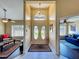 Bright foyer with stylish chandelier, white tile flooring and direct view to the front yard at 2558 Ballard Ave, Orlando, FL 32833