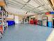 Spacious garage with epoxy floors and storage cabinets. Plenty of room for vehicles and hobbies at 2558 Ballard Ave, Orlando, FL 32833