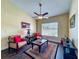 Cozy living room with a ceiling fan, stylish furniture and large window letting in natural light at 2558 Ballard Ave, Orlando, FL 32833
