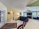 Bright living room with ample windows, a ceiling fan, tiled floor, and comfortable seating area is open to the kitchen at 2558 Ballard Ave, Orlando, FL 32833