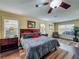 Inviting main bedroom with a large bed, ceiling fan, and natural light from windows, creates a cozy retreat at 2558 Ballard Ave, Orlando, FL 32833