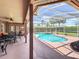 Beautiful in-ground pool surrounded by a screened enclosure, patio, and outdoor seating area, ideal for relaxation at 2558 Ballard Ave, Orlando, FL 32833