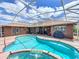 Sparkling in-ground pool and spa with a screened enclosure, perfect for outdoor entertaining and leisure at 2558 Ballard Ave, Orlando, FL 32833