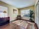 This sitting room features a large window, wood floor, neutral paint, and offers a peaceful space to relax at 2558 Ballard Ave, Orlando, FL 32833