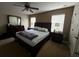 This primary bedroom has a ceiling fan, carpeted floors, and natural light from two windows at 2564 River Landing Dr, Sanford, FL 32771