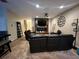Modern living room featuring a decorative fireplace, a ceiling fan, and an accent wall at 2564 River Landing Dr, Sanford, FL 32771
