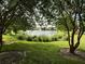 A serene view of the pond with a fountain as seen through lush foliage at 2564 River Landing Dr, Sanford, FL 32771