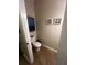 Cozy powder room with neutral paint, framed artwork, and floating shelves at 2564 River Landing Dr, Sanford, FL 32771