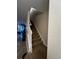 Carpeted staircase with a white railing leading to the upper level of the home at 2564 River Landing Dr, Sanford, FL 32771