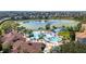 Aerial view of the community pool, splash park, lake, and landscaping at 2616 Bowring St, Kissimmee, FL 34747