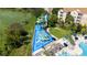 Aerial view of splash park with water slides and pool with sun loungers and lake at 2616 Bowring St, Kissimmee, FL 34747