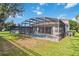 Spacious backyard with screened pool, spa, patio, and well-maintained landscaping at 2616 Bowring St, Kissimmee, FL 34747
