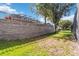 Stone retaining wall and fence provide privacy to the backyard at 2616 Bowring St, Kissimmee, FL 34747