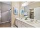 Bright bathroom features double sinks, vanity and walk-in shower at 2616 Bowring St, Kissimmee, FL 34747