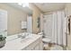 Bright bathroom featuring a shower/tub combo, white cabinets, and modern fixtures at 2616 Bowring St, Kissimmee, FL 34747