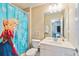 Cozy bathroom featuring a Frozen-themed shower curtain, white vanity, and modern fixtures at 2616 Bowring St, Kissimmee, FL 34747
