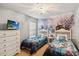 Charming bedroom featuring twin beds with colorful Frozen-themed decor and a themed accent wall at 2616 Bowring St, Kissimmee, FL 34747