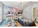 Bright bedroom featuring twin beds with Frozen bedding and a Frozen themed accent wall at 2616 Bowring St, Kissimmee, FL 34747