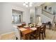 Comfortable dining area provides a wooden table, seating for six, and views into the staircase at 2616 Bowring St, Kissimmee, FL 34747
