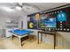 Finished game room with a pool table, washer, dryer and Pac-Personal themed decor at 2616 Bowring St, Kissimmee, FL 34747