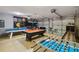 Spacious game room featuring foosball, pool table, and game themed decor at 2616 Bowring St, Kissimmee, FL 34747
