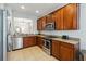Well-lit kitchen features stainless steel appliances, granite countertops and ample cabinetry at 2616 Bowring St, Kissimmee, FL 34747