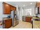 Kitchen featuring stainless steel appliances, wood cabinets and granite countertops at 2616 Bowring St, Kissimmee, FL 34747