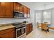 Bright kitchen with granite countertops, stainless steel appliances, and an adjacent breakfast nook at 2616 Bowring St, Kissimmee, FL 34747