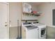 Functional laundry room equipped with modern washer and dryer, and storage solutions for efficient chores at 2616 Bowring St, Kissimmee, FL 34747