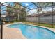 Inviting screened-in pool area with attached spa and brick-paved deck at 2616 Bowring St, Kissimmee, FL 34747