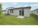 A well-maintained backyard features a sliding glass door to the home and plenty of green grass at 2778 Virginia Pine Dr, Bartow, FL 33830