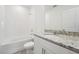 Bathroom featuring a granite vanity and tub with white tile surround at 2778 Virginia Pine Dr, Bartow, FL 33830
