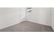 Comfortable bedroom with neutral carpet, window with blinds and a door at 2778 Virginia Pine Dr, Bartow, FL 33830