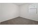 Bright, carpeted bedroom featuring a window with white blinds at 2778 Virginia Pine Dr, Bartow, FL 33830