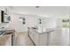 Well-lit kitchen with granite counters, stainless appliances, and island with sink and seating at 2778 Virginia Pine Dr, Bartow, FL 33830
