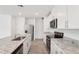 Modern kitchen with granite countertops, stainless steel appliances, and white cabinetry at 2778 Virginia Pine Dr, Bartow, FL 33830
