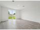 Spacious living area with tiled flooring and sliding glass doors overlooking the backyard at 2778 Virginia Pine Dr, Bartow, FL 33830