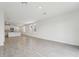 Large, open living space with tiled floors, bright white walls, and kitchen access at 2778 Virginia Pine Dr, Bartow, FL 33830