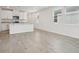 Open-concept living space with tiled floors, white walls, and a kitchen with granite countertops at 2778 Virginia Pine Dr, Bartow, FL 33830