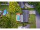 Home from above features backyard pool, mature trees, and lush green lawn at 2809 Sanbina St, Winter Park, FL 32789