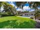Expansive backyard with lush green lawn and privacy hedges creates a private oasis at 2809 Sanbina St, Winter Park, FL 32789