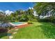 Landscaped backyard features a refreshing pool and mature trees, perfect for outdoor enjoyment at 2809 Sanbina St, Winter Park, FL 32789