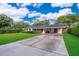 Charming single-story home with a well-maintained lawn and covered carport in a desirable neighborhood at 2809 Sanbina St, Winter Park, FL 32789