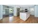Modern kitchen featuring stainless steel appliances, an island, and ample cabinet space at 2809 Sanbina St, Winter Park, FL 32789